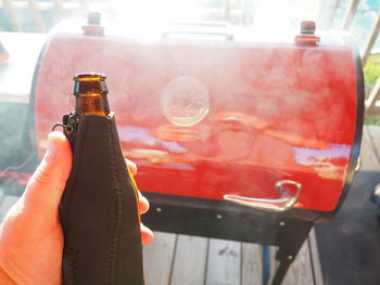 Close-up of hand holding bottle