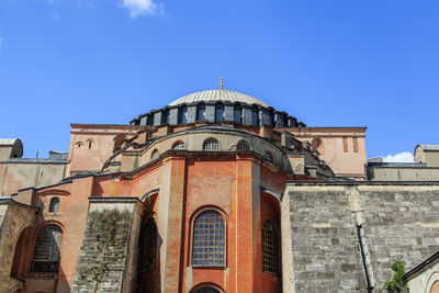 Low angle view of mosque against blue sky