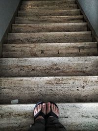 Low section of man standing on staircase