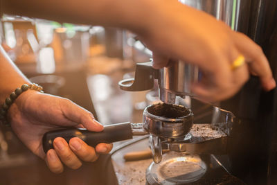 Cropped hand of man preparing food in kitchen