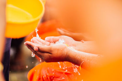 Close-up of hand collecting water 