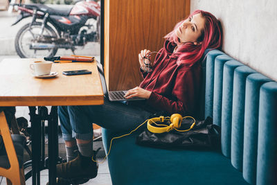 Portrait of young woman using mobile phone