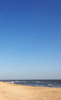 Scenic view of beach against clear blue sky