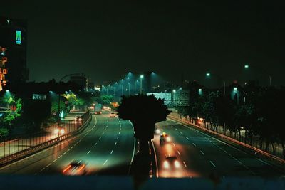 Cars on road in city at night