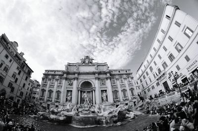 Buildings against cloudy sky