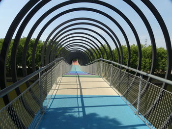 Low angle view of footbridge against sky