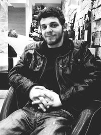 Portrait of smiling man sitting outdoors