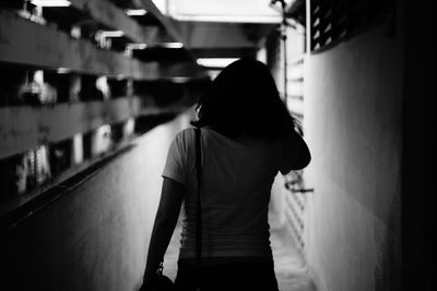 Young woman standing on corridor