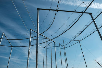 Low angle view of electricity pylon against sky