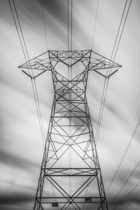 Low angle view of electricity pylon against sky