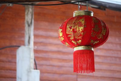 Low angle view of lanterns hanging by building