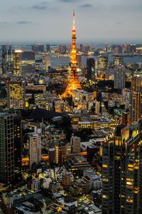 High angle view of illuminated city buildings against sky