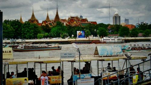 Boats in river with buildings in background