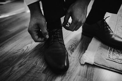 Low section of man working on wooden floor