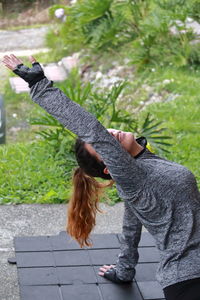 Woman with arms raised on plant