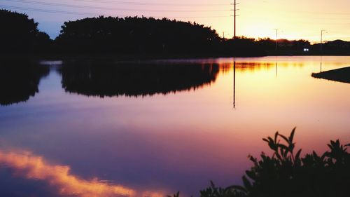 Scenic view of lake against sky at sunset