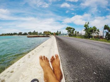 Low section of woman relaxing on beach