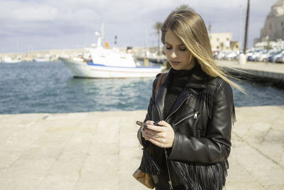 Portrait of young italian woman using the smartphone 