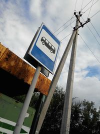 Low angle view of road sign against sky