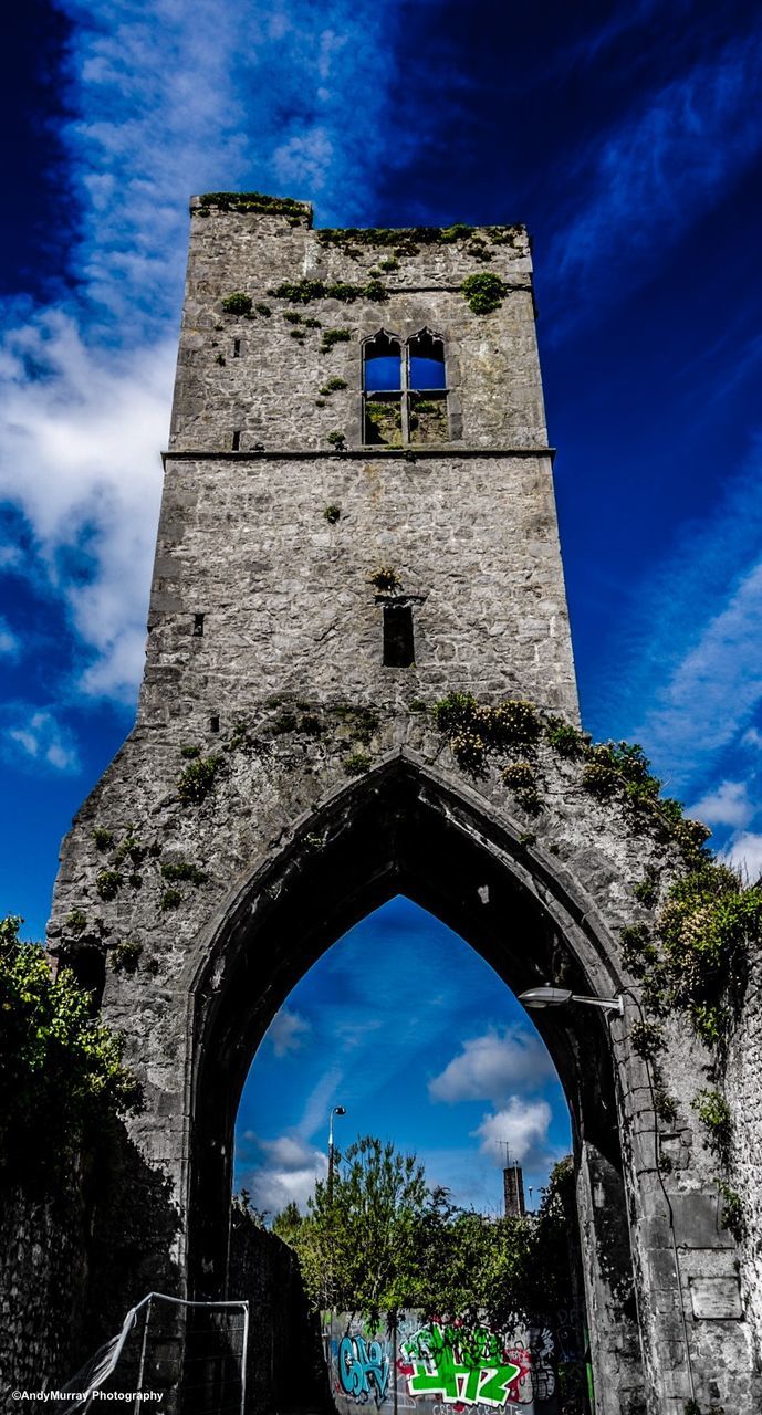 architecture, built structure, building exterior, low angle view, arch, sky, church, blue, religion, history, cloud - sky, place of worship, old, tower, castle, cloud, spirituality, the past