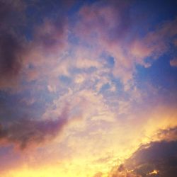 Low angle view of cloudy sky at sunset