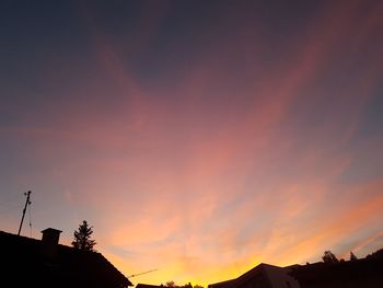 Low angle view of silhouette buildings against sky during sunset