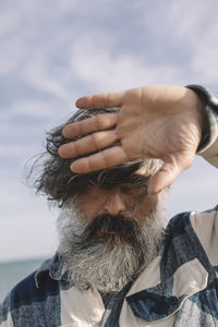 Close-up portrait of a man with tousled hair. hipster, urban, street style.