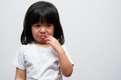 Portrait of cute girl against white background