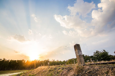 Scenic view of field against sky at sunset