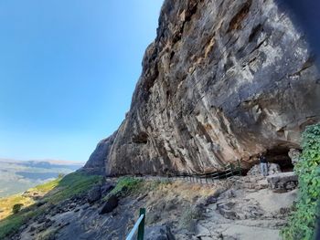 Low angle view of rock formation against sky