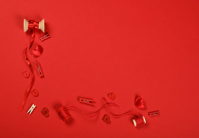 High angle view of decoration on table against red background