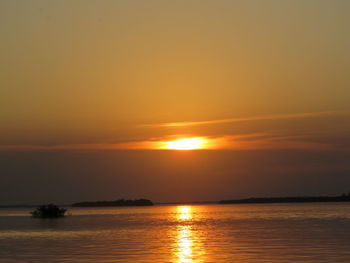 Scenic view of sea against orange sky