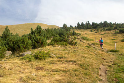 Scenic view of hight land and read view of women waking yo yje submit