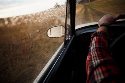 Cropped image of man driving car