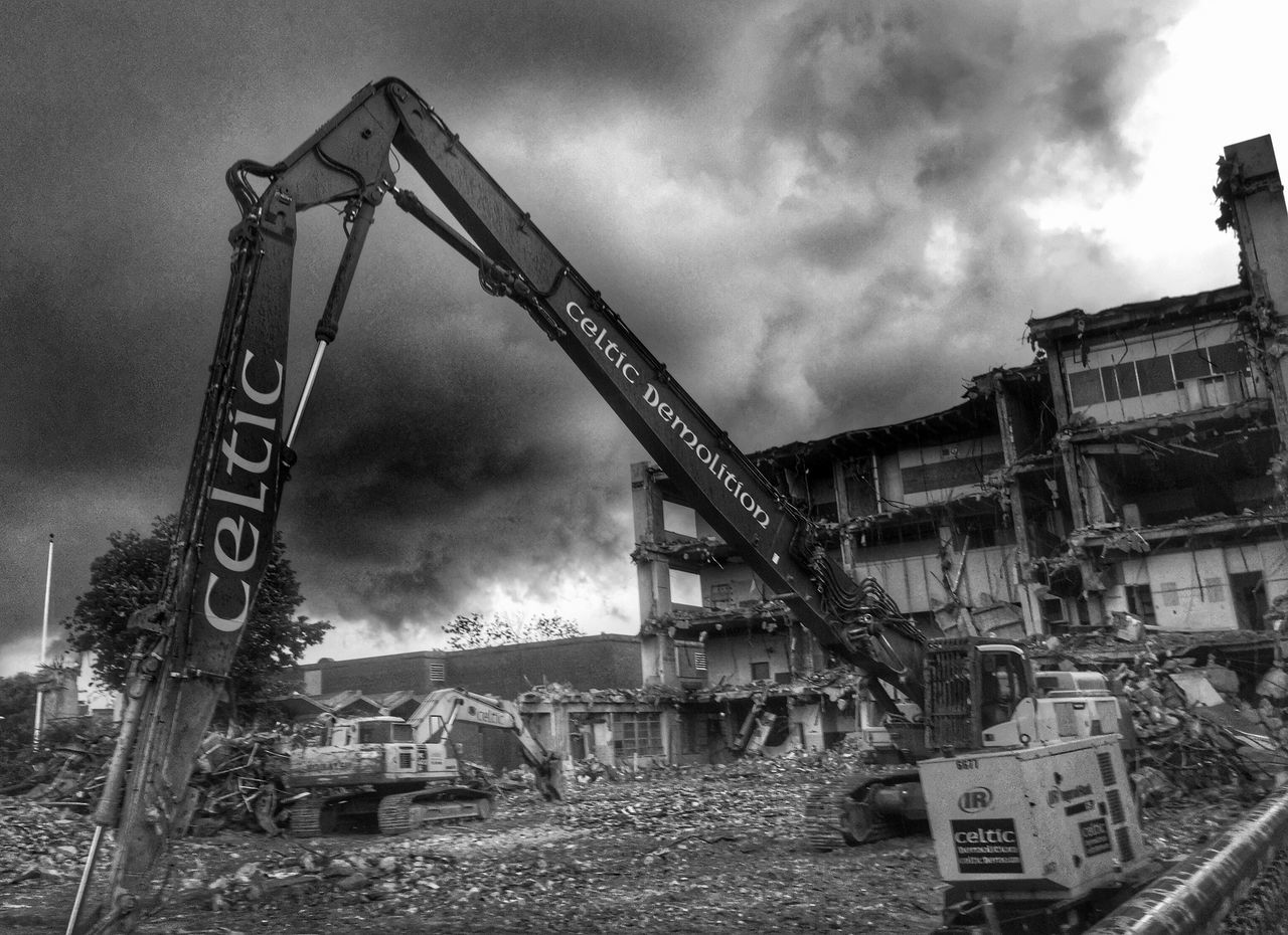 architecture, built structure, sky, building exterior, cloud - sky, abandoned, cloudy, low angle view, obsolete, transportation, run-down, damaged, construction site, industry, deterioration, day, cloud, outdoors, graffiti, old