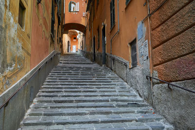 Low angle view of steps amidst buildings