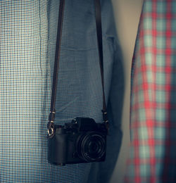 Close-up of man photographing with camera