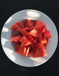 High angle view of chopped fruits in plate on table
