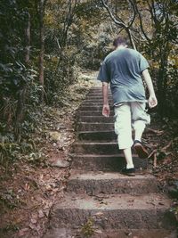 Rear view of woman walking on footpath