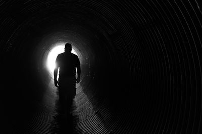 Silhouette people in tunnel