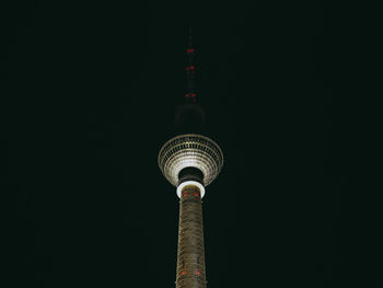 Low angle view of fernsehturm against sky at night