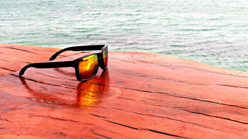 Close-up of sunglasses on beach