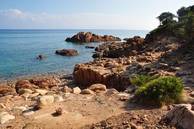Rocks on beach against sky
