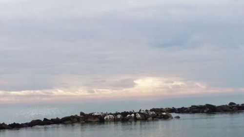 Scenic view of sea against cloudy sky