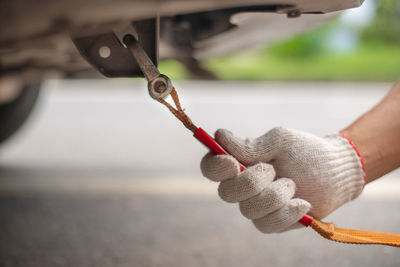 Cropped hand repairing vehicle