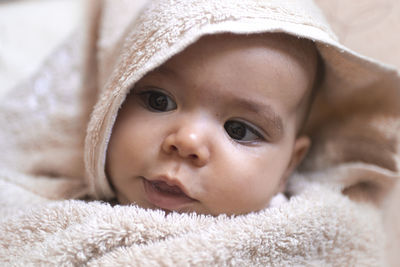 Close-up portrait of cute baby lying down