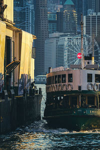 Buildings by river in city