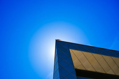 Low angle view of modern building against clear blue sky