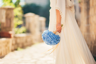Woman holding umbrella standing outdoors