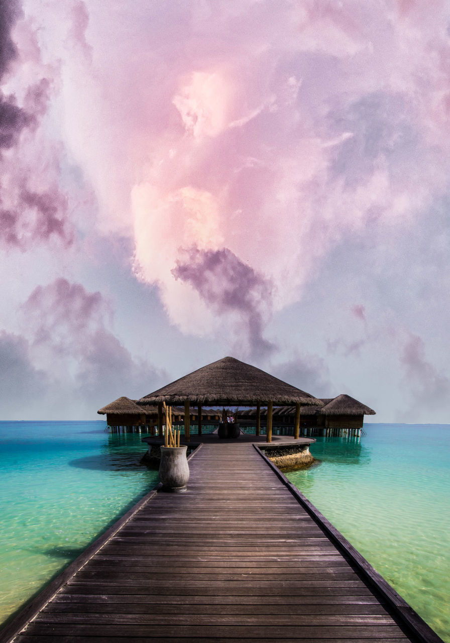 PIER AMIDST SEA AGAINST SKY